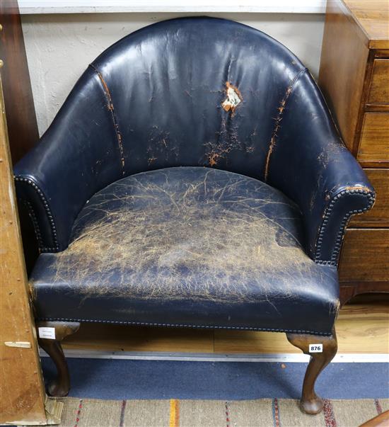 A pair of blue leather tub chairs